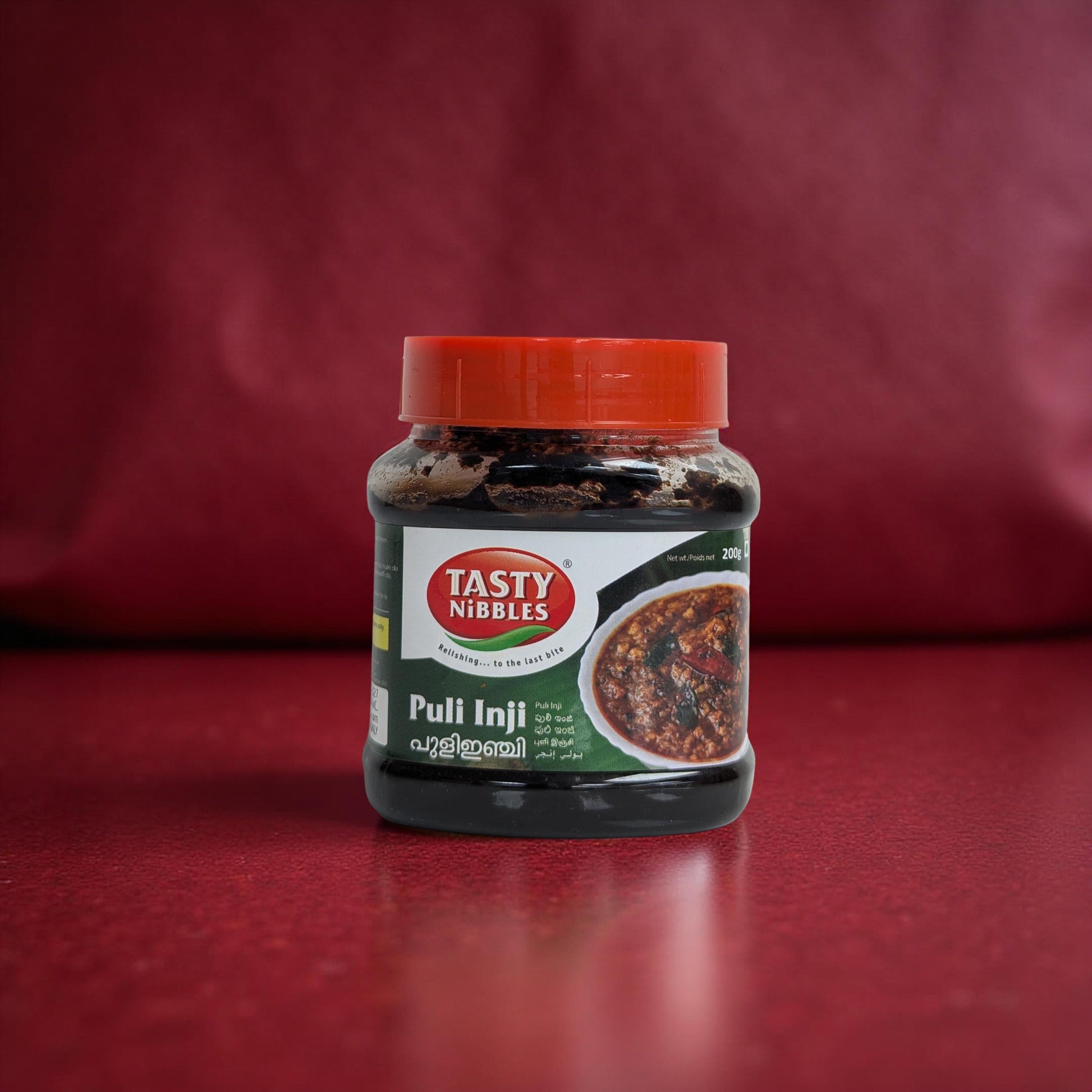Jar of Tasty Nibbles Puli Inji on a red background